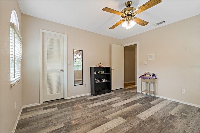 interior space featuring wood-type flooring and ceiling fan