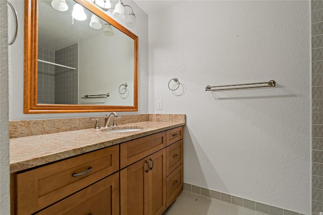 bathroom with tile floors and vanity