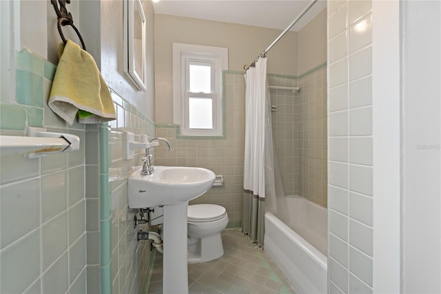 bathroom with tile floors, shower / tub combo, tile walls, and toilet