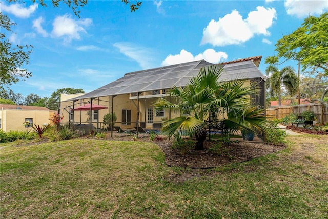 rear view of property featuring a lawn