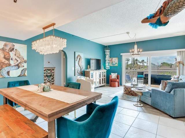 dining room featuring an inviting chandelier, tile floors, and a textured ceiling