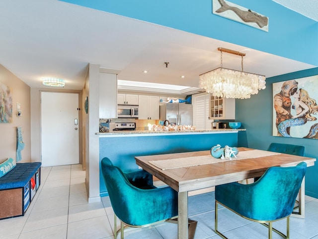 tiled dining area with a notable chandelier