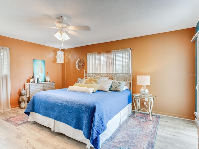 bedroom with ceiling fan and light wood-type flooring