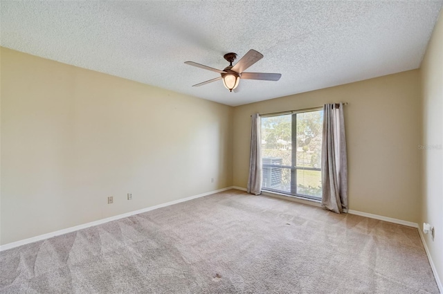 carpeted empty room with ceiling fan and a textured ceiling