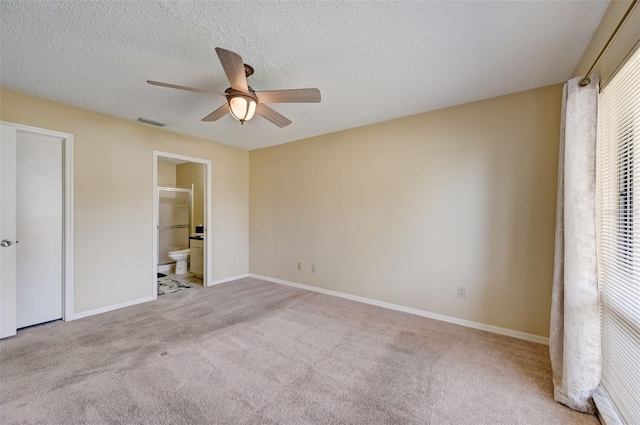 unfurnished bedroom with connected bathroom, ceiling fan, carpet flooring, and a textured ceiling