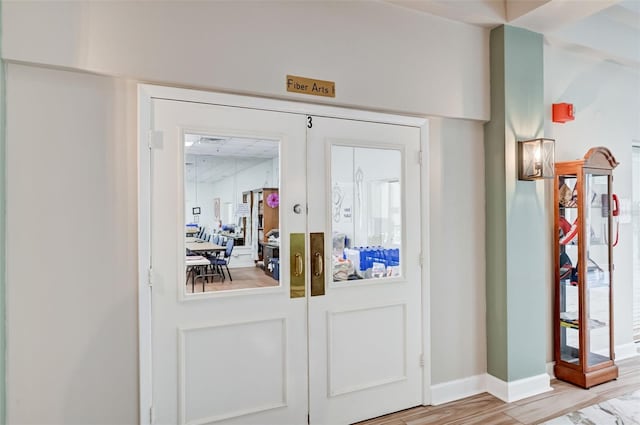 doorway to outside with french doors and light wood-type flooring