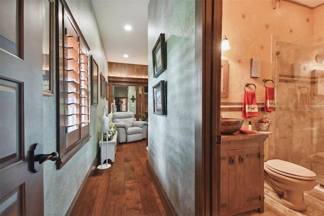 corridor with recessed lighting, baseboards, and wood finished floors