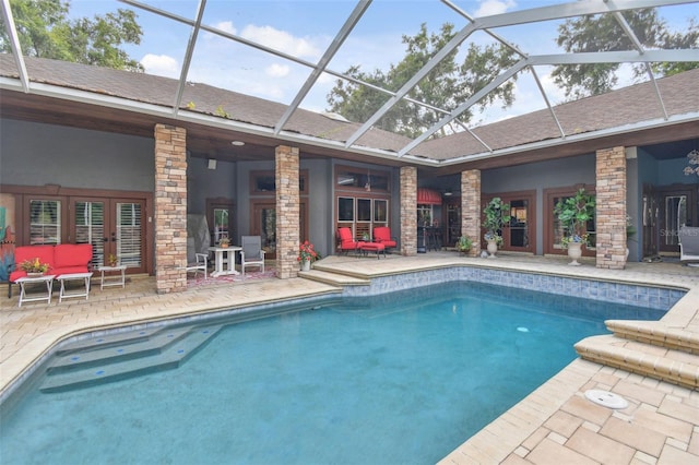 outdoor pool with glass enclosure, a patio area, and an outdoor living space