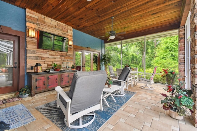 sunroom featuring wood ceiling and ceiling fan