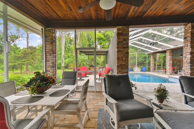 outdoor pool featuring a lanai, ceiling fan, and a patio