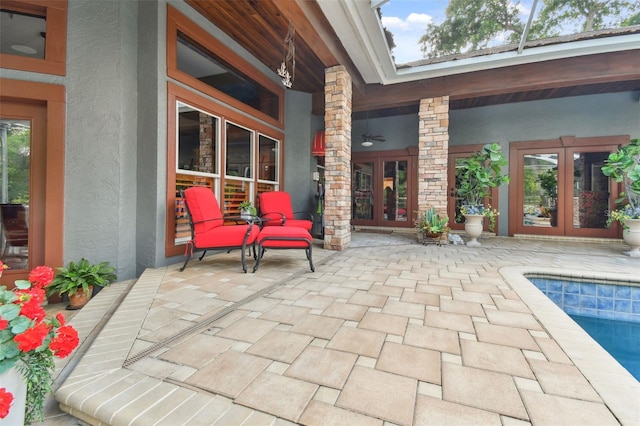 view of patio featuring french doors, an outdoor pool, and ceiling fan