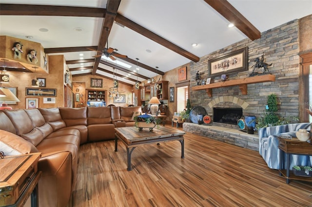 living room featuring vaulted ceiling with beams, a fireplace, ceiling fan, and wood finished floors