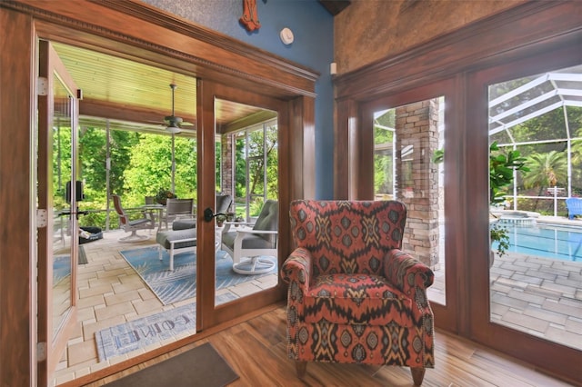 doorway to outside with ceiling fan and wood finished floors