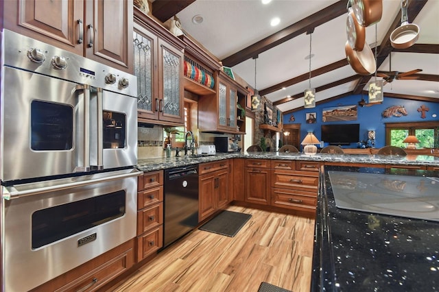 kitchen with black dishwasher, glass insert cabinets, double oven, a sink, and dark stone counters