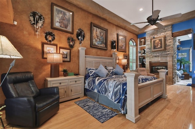 bedroom featuring light wood-style floors and a fireplace