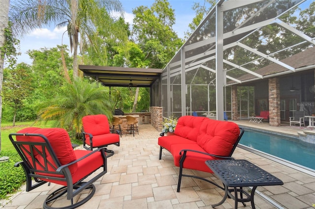 pool featuring glass enclosure, outdoor dry bar, and a patio