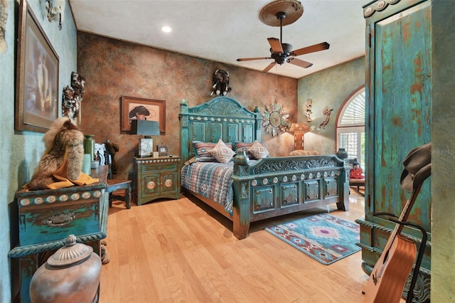 bedroom with a ceiling fan and light wood-style floors