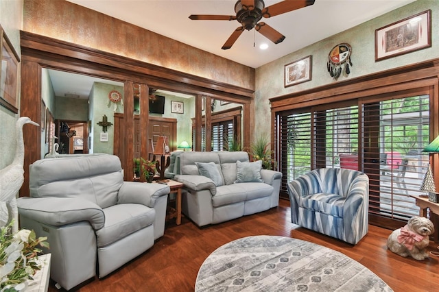 living area with a ceiling fan and dark wood-type flooring