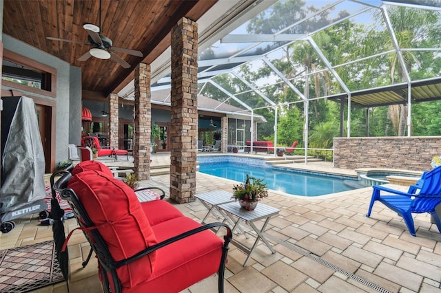 view of pool featuring ceiling fan, a patio area, a lanai, and an outdoor living space