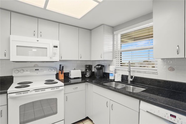 kitchen with white cabinetry, sink, decorative backsplash, and white appliances