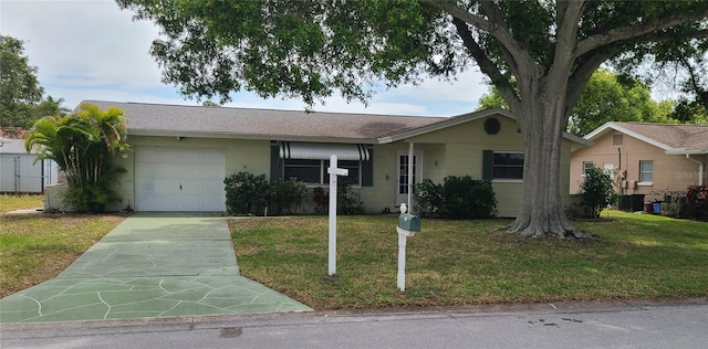 ranch-style home with a front yard, a garage, and central AC unit