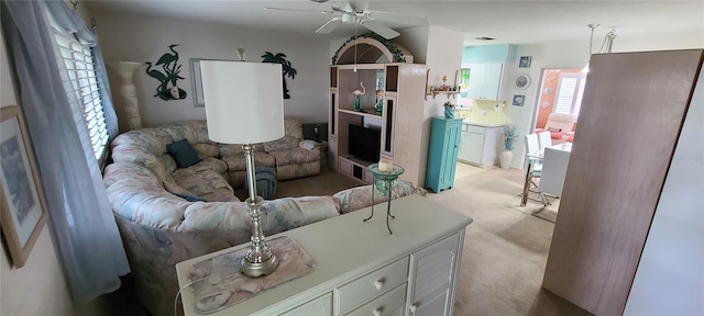 carpeted living room featuring ceiling fan