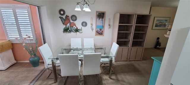 dining room featuring carpet floors and an inviting chandelier