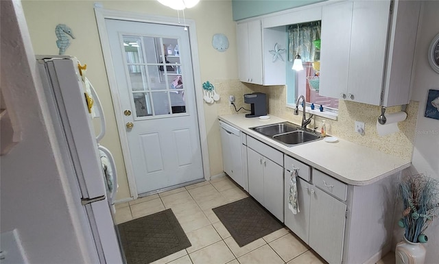 kitchen featuring light tile floors, white cabinets, sink, white appliances, and backsplash