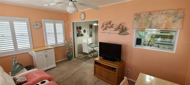 carpeted living room with ceiling fan