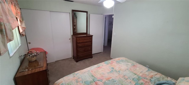 carpeted bedroom featuring a closet and ceiling fan