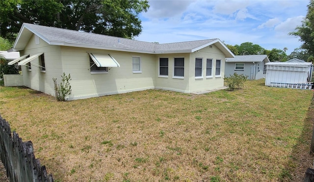 rear view of property with a lawn