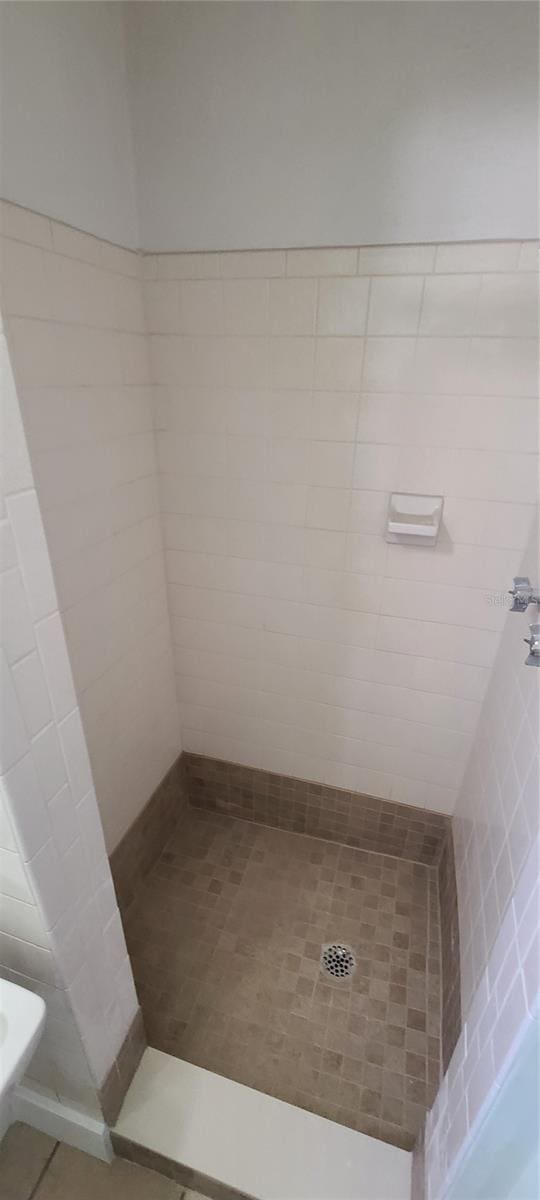 bathroom with tiled shower