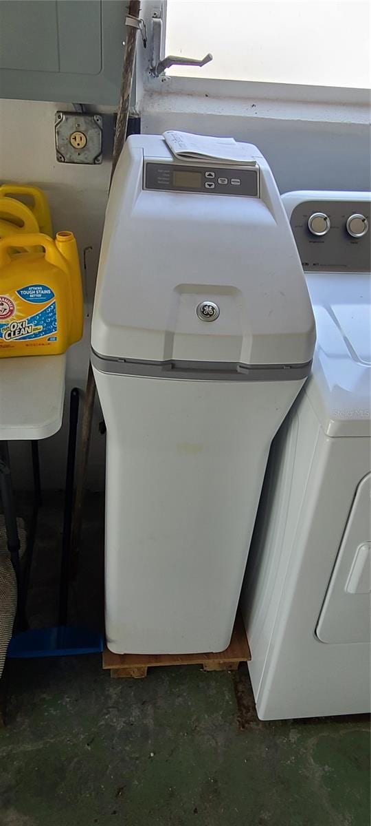 interior details featuring concrete flooring and washer / clothes dryer