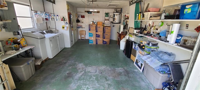 storage room featuring water heater and washing machine and dryer