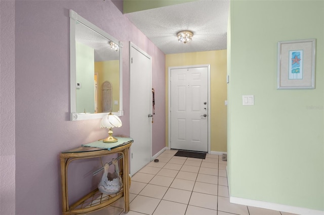 tiled foyer with a textured ceiling