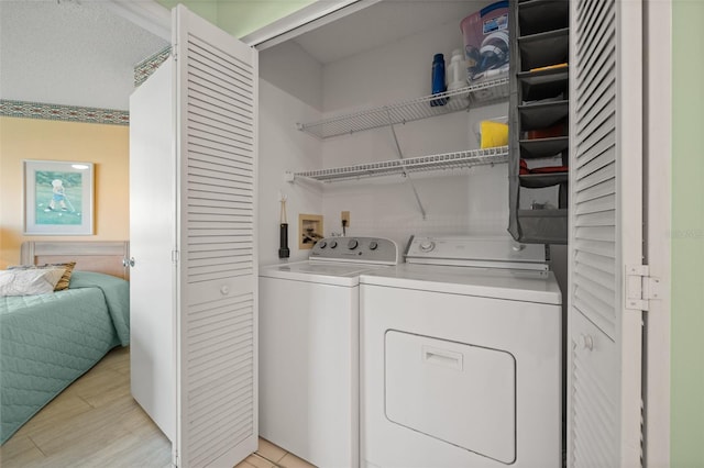 clothes washing area featuring washer hookup and washing machine and clothes dryer