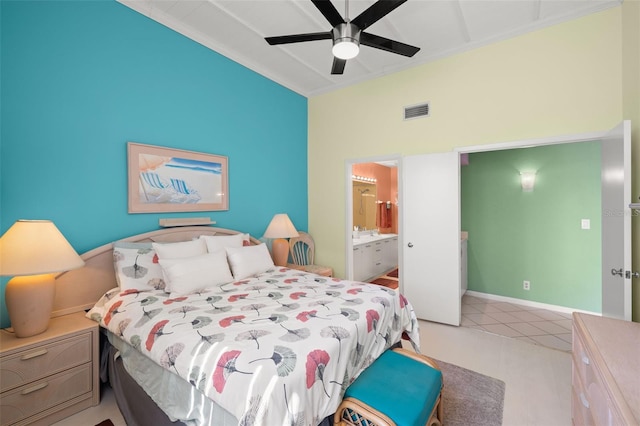 bedroom with ornamental molding, ceiling fan, and ensuite bathroom