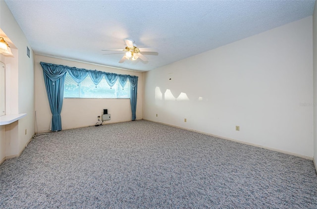 carpeted spare room with ceiling fan and a textured ceiling