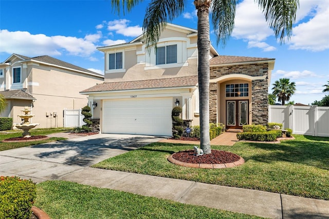 view of front property with a front lawn and a garage