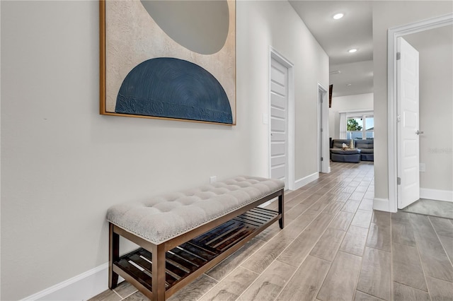 hallway with hardwood / wood-style floors