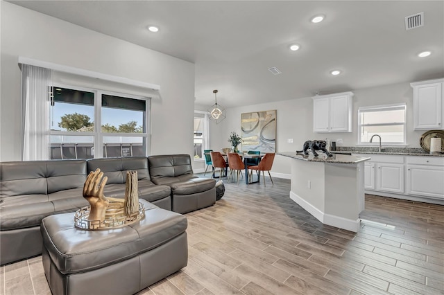 living room featuring sink and light wood-type flooring