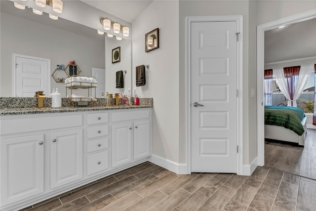 bathroom with wood-type flooring and dual vanity