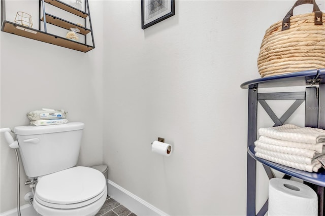 bathroom featuring tile floors and toilet