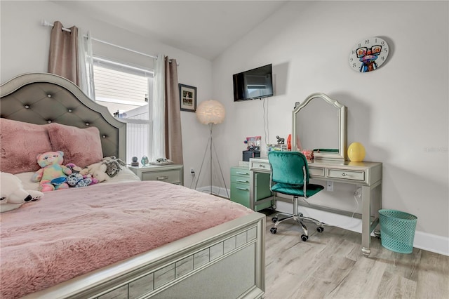 bedroom featuring light wood-type flooring and lofted ceiling