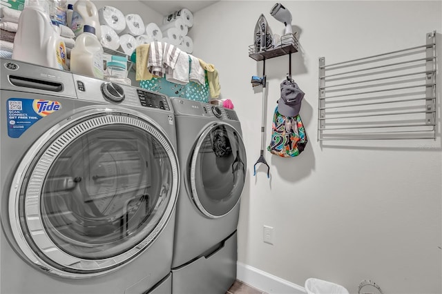 laundry area with radiator and washer and dryer