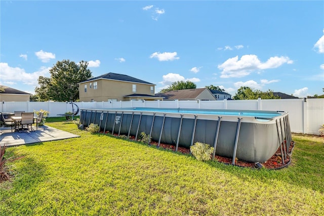 view of yard with a patio and a fenced in pool