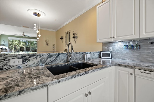 kitchen with stone countertops, ceiling fan, white cabinets, sink, and backsplash