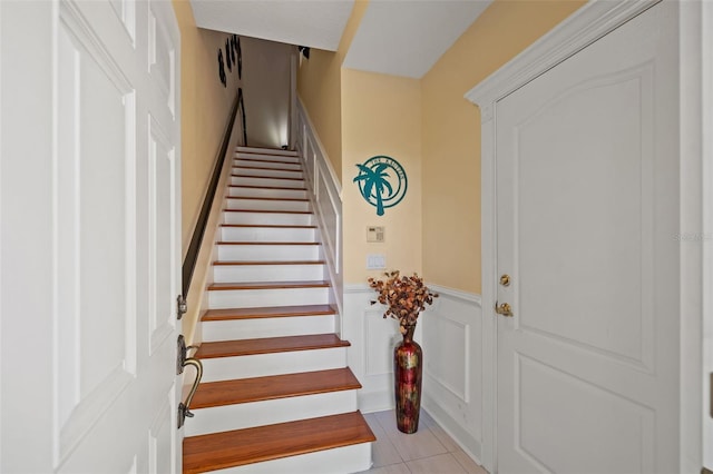 stairway featuring light tile flooring