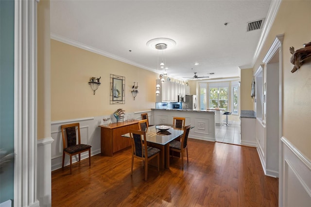 dining area featuring hardwood / wood-style flooring, ornamental molding, and ceiling fan