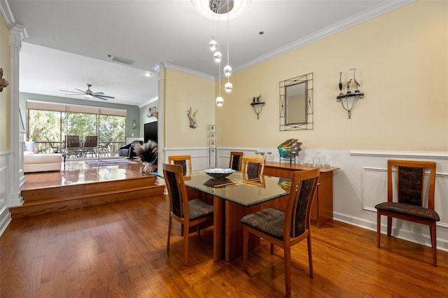 dining space with crown molding, dark wood-type flooring, and ceiling fan